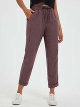 Women's straight-leg outdoor hiking pants in dark mauve with zippered pocket and cuffed hem. #color_Dark Brown
