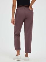 Woman in dark brown straight-leg outdoor hiking pants with cuffed hems and pockets. #color_Dark Brown