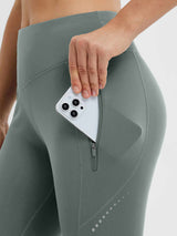 Gray fleece-lined cycling leggings with a phone in a zippered pocket and reflective dots. #color_Dark Gray
