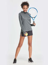 Woman in gray UPF 50+ hiking shirt and black shorts holding tennis racket and ball. #color_Dark Gray