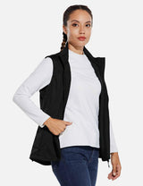 Black windproof softshell vest on a woman with a white long-sleeved shirt and blue jeans. #color_Black