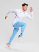 Men's light blue fleece-lined cycling tights with ankle zippers and reflective detail. Paired with white athletic top.