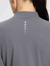 Grey thermal ski base top with ribbed texture and reflective dot detail on back.