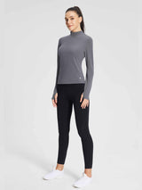 Grey long-sleeve thermal base top with mock neck and thumbholes for skiing and layering. #color_Lavender Gray