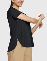 Woman wearing black UPF 50+ short sleeve tee and tan DWR shorts, stretching arms. #color_Black