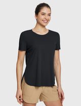Woman in black UPF 50+ short sleeve tee & tan casual shorts, ideal for adventure. #color_Black