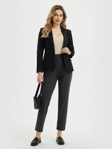 Black blazer and dark gray cropped pants on woman with cream camisole, black purse, and loafers. #color_Black