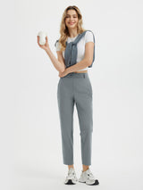 Woman in light grey 27" golf pants holding a coffee cup. #color_Dark Gray