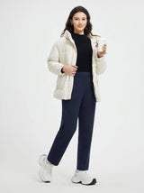 Woman in cream puffer jacket and navy pants holding coffee, modeling Golf Pleated Fleece Slim-Fit Pants #color_Navy Blue