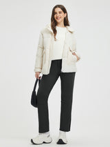 Woman in black fleece ski pants and cream knit jacket. Features adjustable waistband, 3D knee. #color_Black