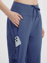 Women's navy blue hiking shorts with drawstring waist and phone in zippered pocket. #color_Navy Blue