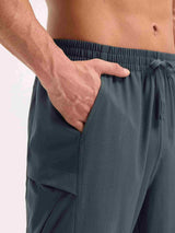 Men's dark gray woven hiking joggers with elastic waistband and drawstring. Close-up of hand in pocket. #color_Dark Gray