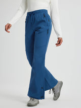 Woman wearing blue softshell outdoor pants with zipper pockets and adjustable snap closures. #color_Cobalt Blue