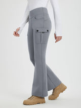 Woman wearing gray fleece-lined flared workwear pants with cargo pockets and a white long-sleeved shirt. #color_Dark Gray