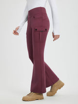 Maroon fleece-lined flared workwear pants with cargo pockets and button closure. Model wears white top and tan boots. #color_Wine Red