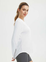 White women's long sleeve running shirt with reflective dots on side seam and thumbholes #color_White