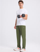 Man in white t-shirt and olive green joggers lifting a dumbbell. #color_Army Green