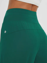 Dark green women's capris: high waistband, subtle Baleaf logo, breathable fabric. UPF 50+ running pants. #color_Dark Green