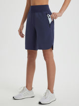 Women's navy blue 9" high-waisted running shorts with zippered pockets. #color_Navy Blue