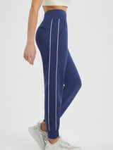 Navy blue fleece-lined joggers with white side stripes and zippered pockets. #color_Blue/White