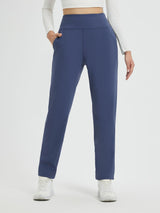 Women's navy blue heavyweight thermal fleece tapered running pants with pockets and a white top. #color_Navy Blue