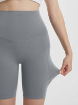 Close-up of grey women's 8" super high-waisted biker shorts showing stretchy fabric and side pocket. #color_Dark Gray