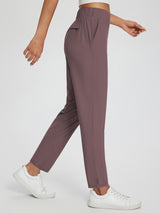 Mauve tapered yoga pants with high waist, side pockets, and ankle slit. #color_Dark Brown