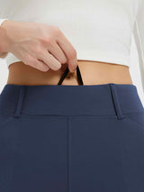 Woman pulling the drawstring of navy blue fleece-lined high-waisted leggings with pockets. #color_Navy Blue
