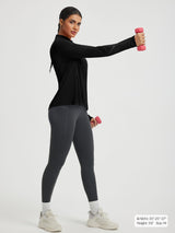 Black Baleaf UPF 50+ half zip cycling jersey worn by woman exercising with dumbbells. #color_Black