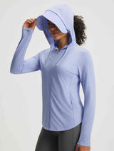 Light purple UPF 50+ sun jacket with removable brim, woman adjusting hood for casual trail wear. #color_Blue