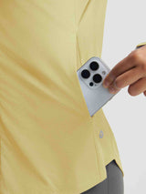 Textured yellow UPF 50+ shirt pocket detail: hand inserts smartphone. #color_Yellow