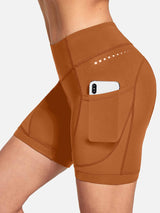 Brown women's V-waist cycling shorts with side pockets holding a phone and dotted accent. #color_Brown