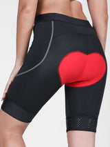 Women's black cycling shorts with red 4D gel padding and anti-slip leg grips. #color_Dark Gray