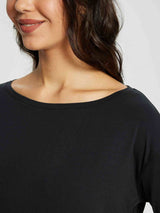Women's black long-sleeve workout shirt showcasing a stylish boat neckline and soft fabric. #color_Black