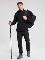 Man in black jacket and pants holding trekking pole, ready for outdoor adventure #color_Black