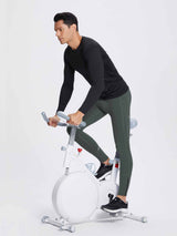 Men's dark green fleece-lined winter running tights with zippered ankles, worn while cycling #color_Dark Gray