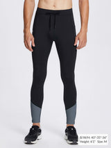 Men's black fleece-lined winter running tights with gray leg panels, featuring drawstring waist and athletic fit.