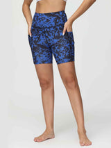 Women's blue and black printed 6" high-waisted yoga shorts with side pockets.