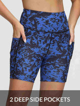 Women's 6" high-waisted yoga shorts in blue with black abstract print, featuring two deep side pockets.