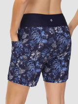 Navy blue women's swim shorts with white/blue tropical print, high waist, pockets. #color_Print 1
