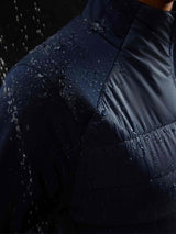 Women's navy quilted jacket with water beads demonstrating water-resistance.