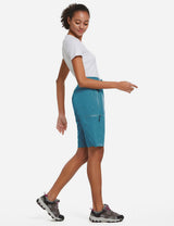 Woman in white tee and blue UPF50+ DWR shorts with zip pockets, part of active set. #color_Blue.