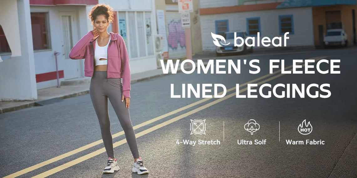 A person standing on a city street wearing stylish hiking pants, with hands on hips and a confident stance.