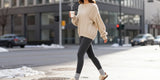 Stylish winter street look with fleece lined leggings and oversized knit sweater