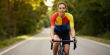 Woman riding road bike wearing comfortable padded bike shorts women on sunny road
