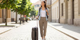 woman packing light, cobblestone street, travel essentials, weekend trip packing list