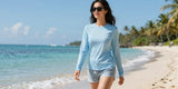Woman relaxing on tropical beach wearing stylish womens upf 50 tops for sun protection