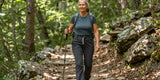 Active woman wearing the best hiking pants for women over 50 on sunny trails.
