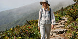 Caucasian hiker wearing loose light-colored outdoor clothes for hot and humid weather on trail.