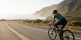 Cyclist riding a road bike along a coastal road